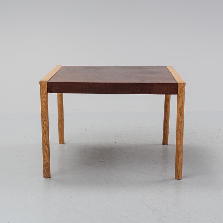 An oak and leather coffee table, mid 20th Century.