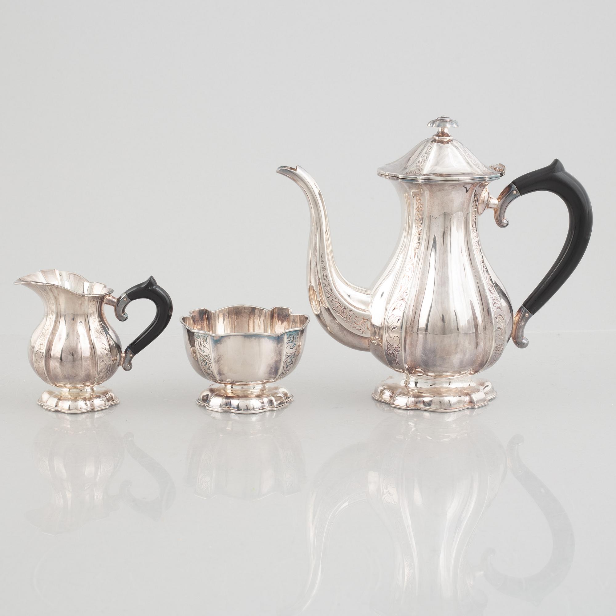 A silver coffee pot, creamer and sugarbowl, Swedish import marks, JL Hultman, circa mid-20th century.