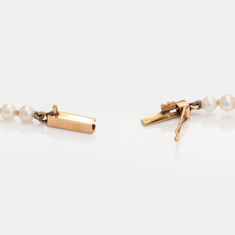 A graduated cultured pearl necklace, clasp in 14K gold.