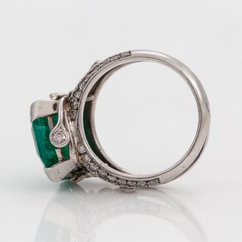 An octagonal cut 6.50 ct emerald and brilliant cut diamond ring. Mandelstam 'Ice Age'.