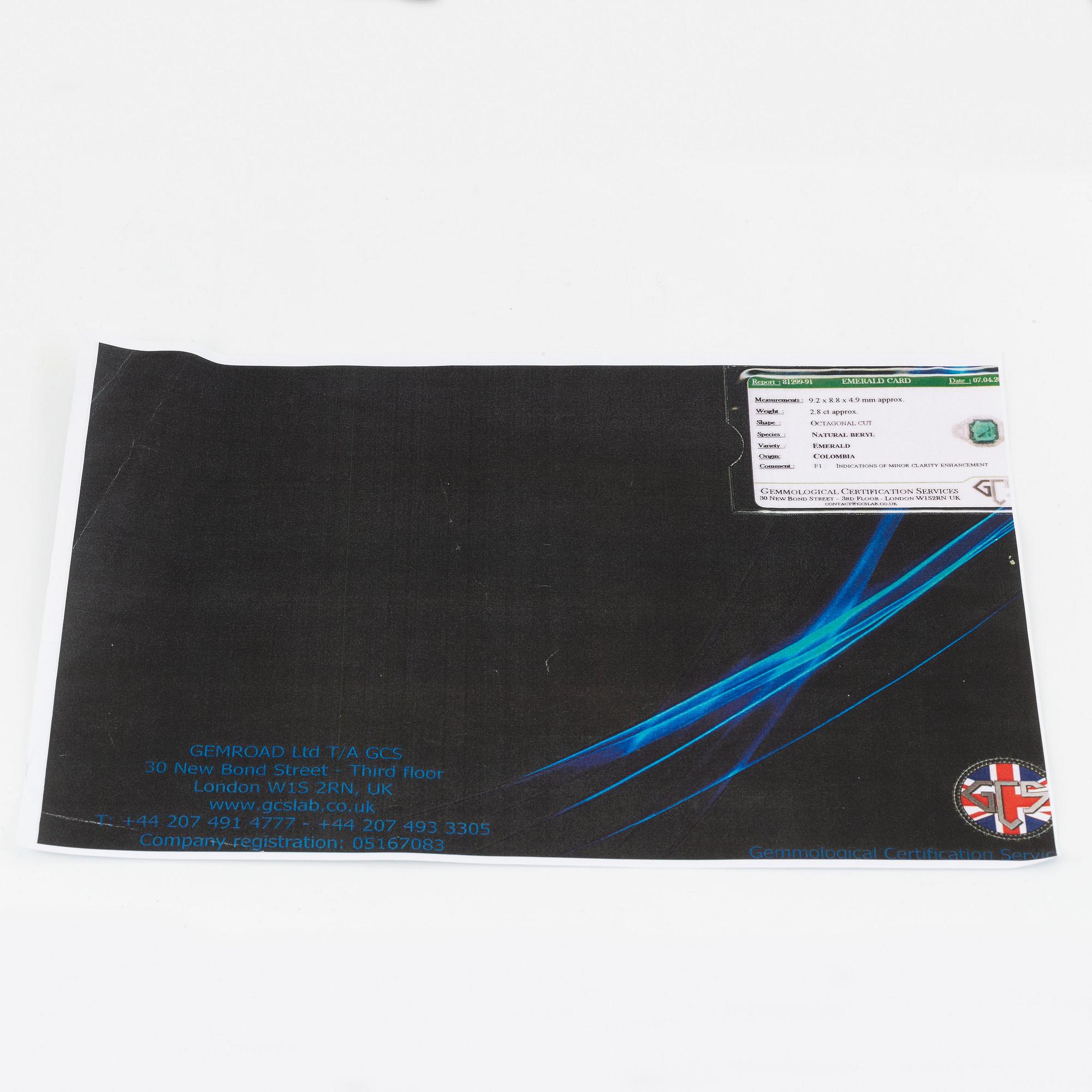 A Bulgari "Trombino" ring in platinum set with a step-cut emerald and round brilliant- and baguette-cut diamonds.