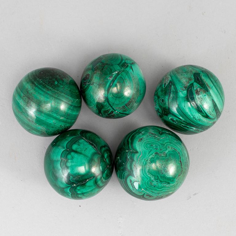 Five malachite balls, 20th century.