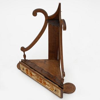 A pipestand and four pipes, circa 1900.