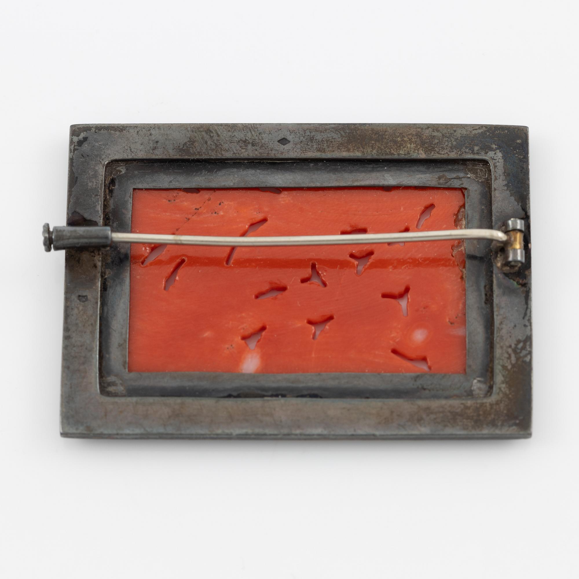 Brooch in silver with coral and marcasites, and with black details.