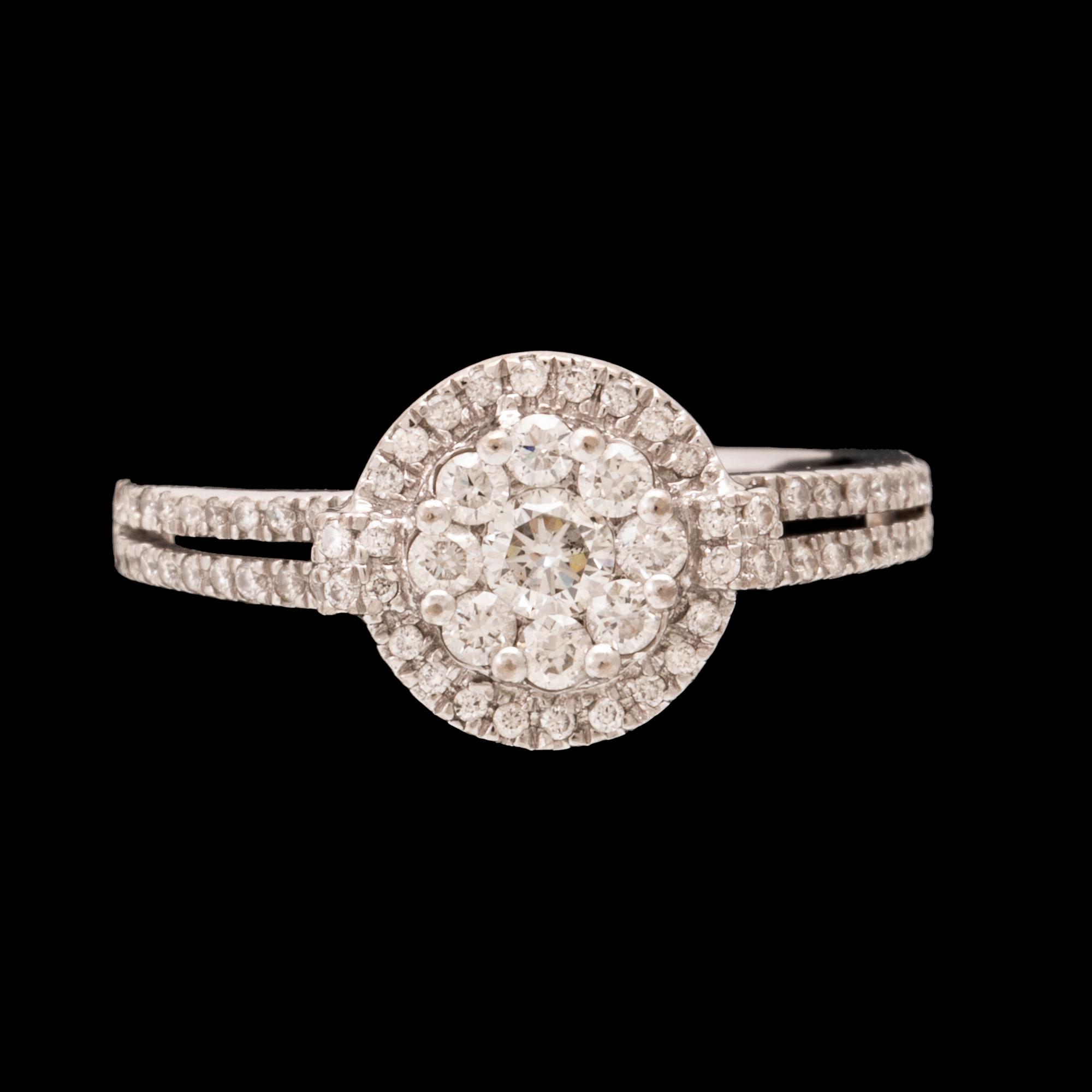 An 18K white gold ring set with round brilliant-cut diamonds.