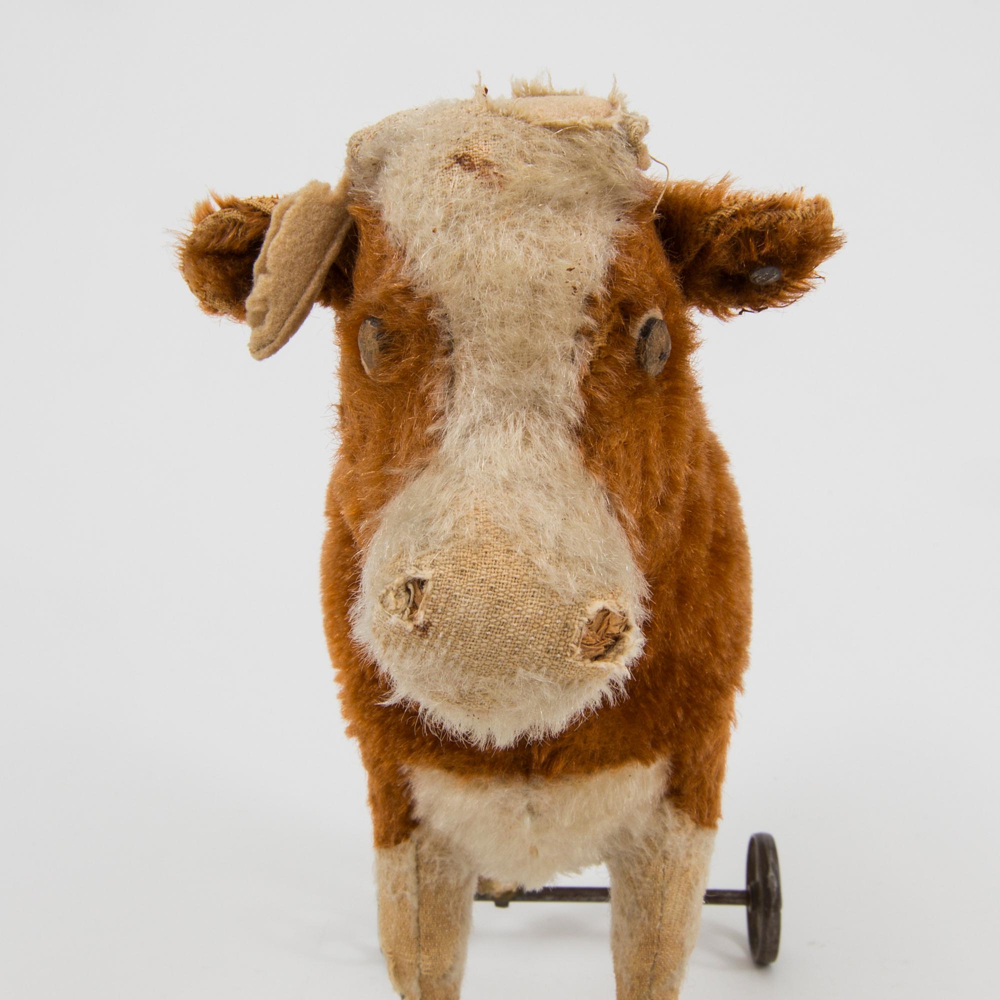 A Steiff cow and a Schuco "Tricky", Germany, 1910 and 1930/40s.