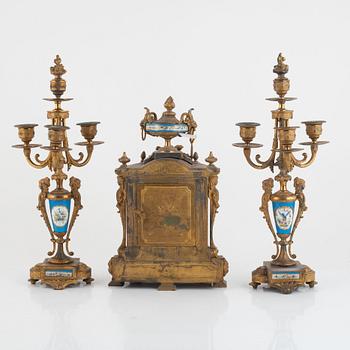 A pair of candelabras and a mantel clock, late 19th Century.