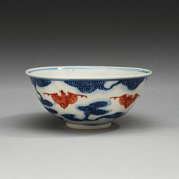 A blue and white bowl with bats in copper red, late Qing dynasty with Quangxu  six character mark.