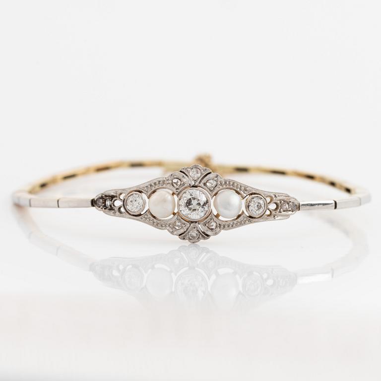 A 14K gold and platinum bracelet set with old- and rose-cut diamonds and pearls.