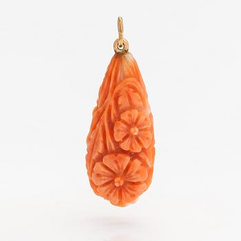 A pendant with carved coral and gold.