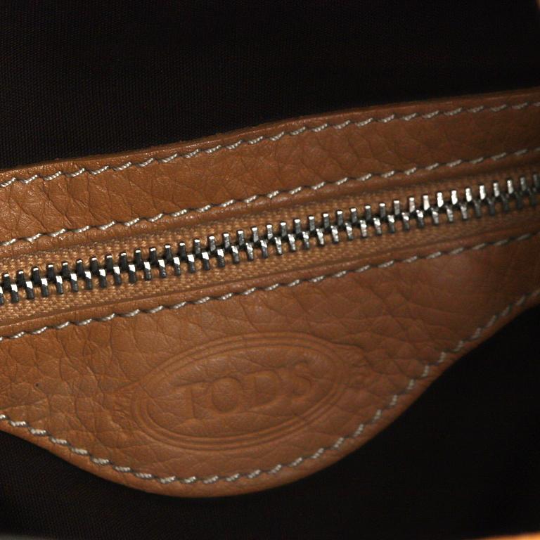 TOD'S, a tan leather bag.