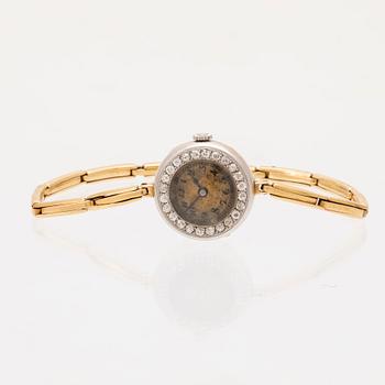 An 18K white and red gold watch set with round old cut diamonds.
