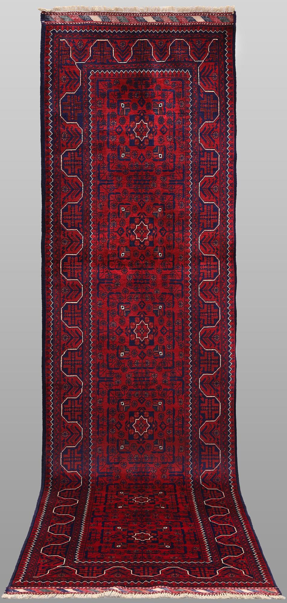 A Afghan runner carpet, 304 x 84 cm.