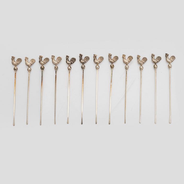 A set of 12 silver glass coasters, Auran Kultaseppä Oy Turku 1935 and 1983, and cocktail sticks, 12 pcs silver.