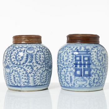 Two similar Chinese blue and white porcealin jars with wooden covers, Qing dynasty, 19th Century.