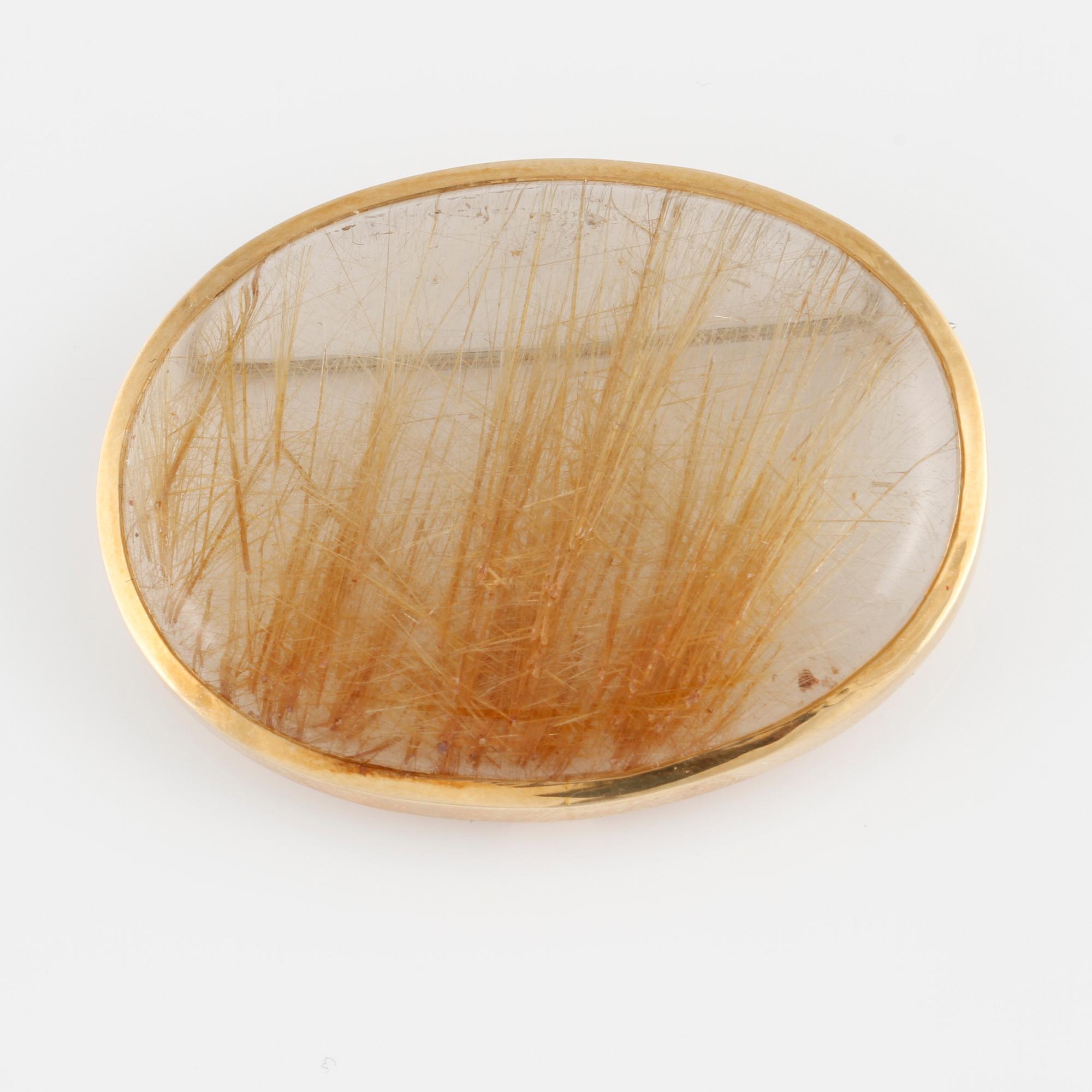 BROSCH, 18K guld med cabochonslipad rutilkvarts. Vikt 17,5 gram.
