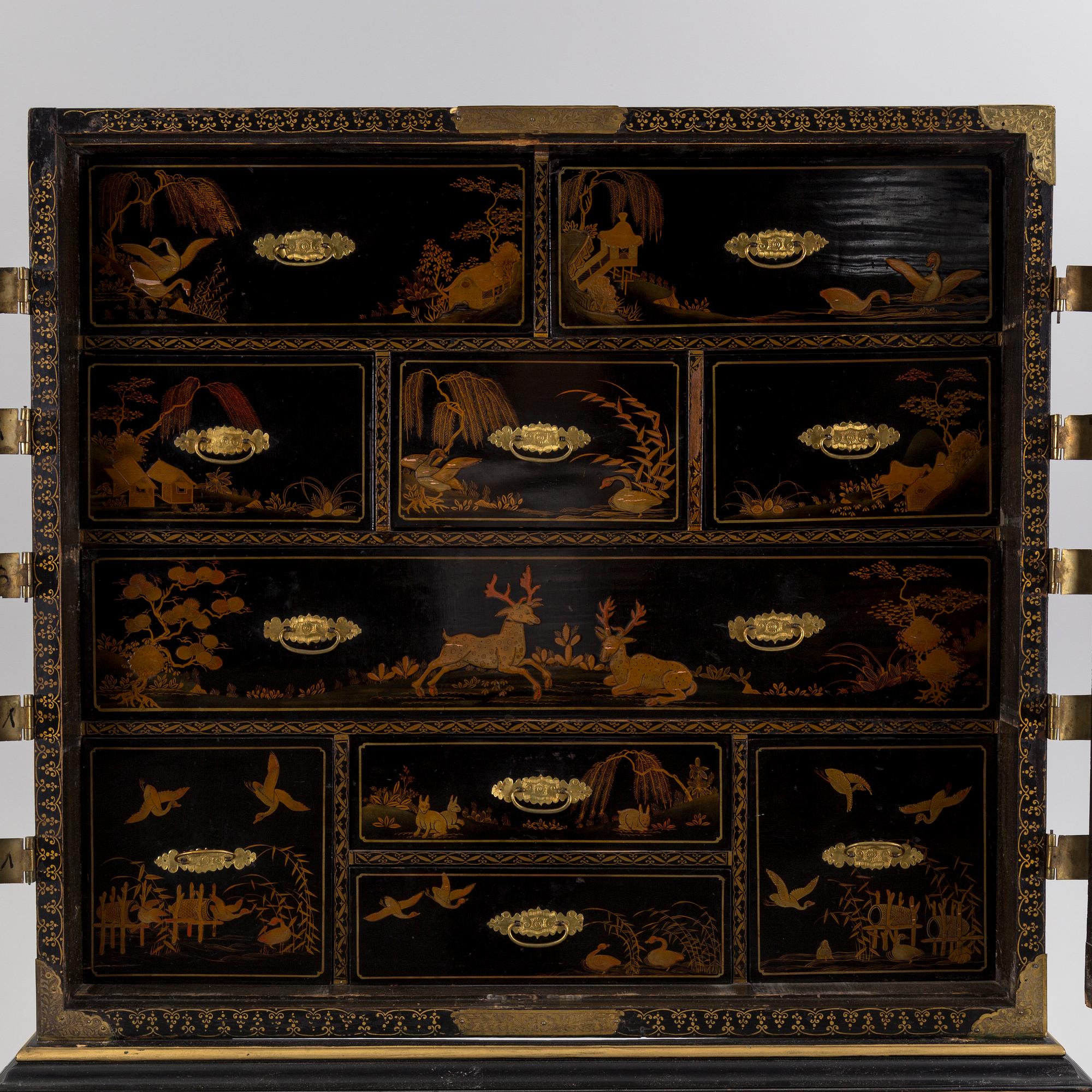 AN early 18TH CENTURY PROBABLY ENGLISH Japanned laquer cabinet on stand.