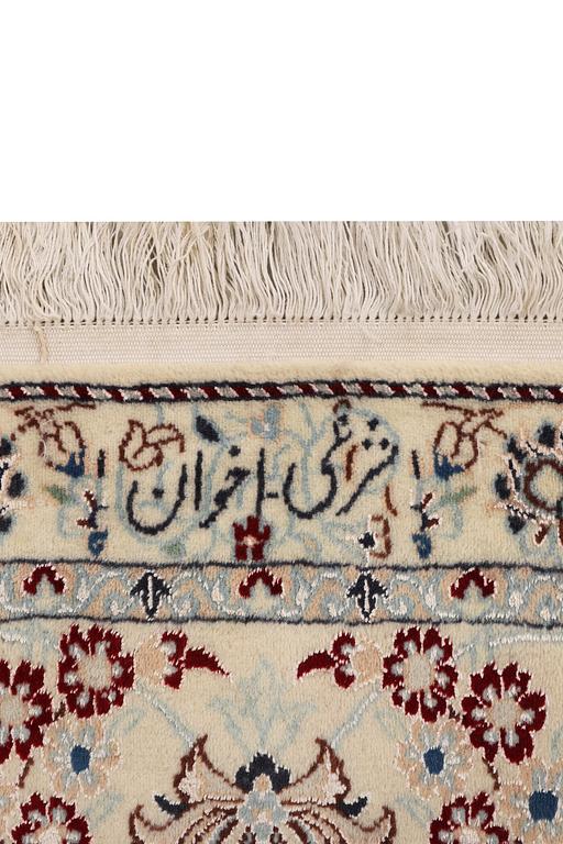 A Nain carpet, part silk, 6 laa, signed, c. 295 x 205 cm.