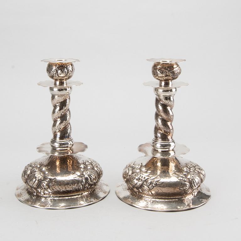 A pair of silver baroquestyle candlesticks. W.H.H, Stockholm. 1935. Filled foot.