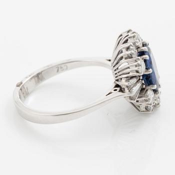 Ring in 18K white gold set with a faceted sapphire and round brilliant-cut and modified baguette-cut diamonds.