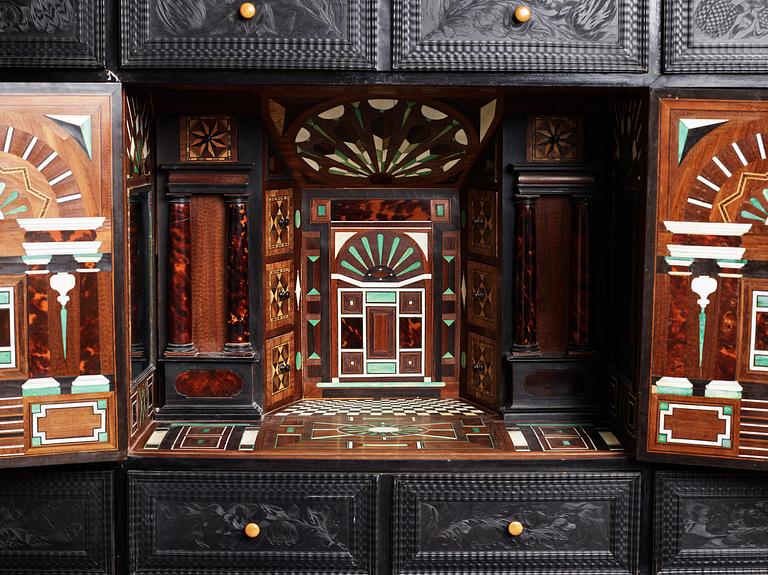 A Louis XIV and Louis XIV-style carved ebony, ivory and tortoiseshell-inlaid cabinet on stand, 17th and 19th century.