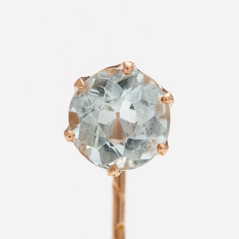 A 14K gold tiepin with a aquamarine.