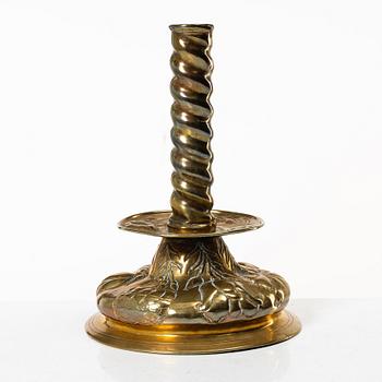 A Baroque brass candle stick, 18th century.