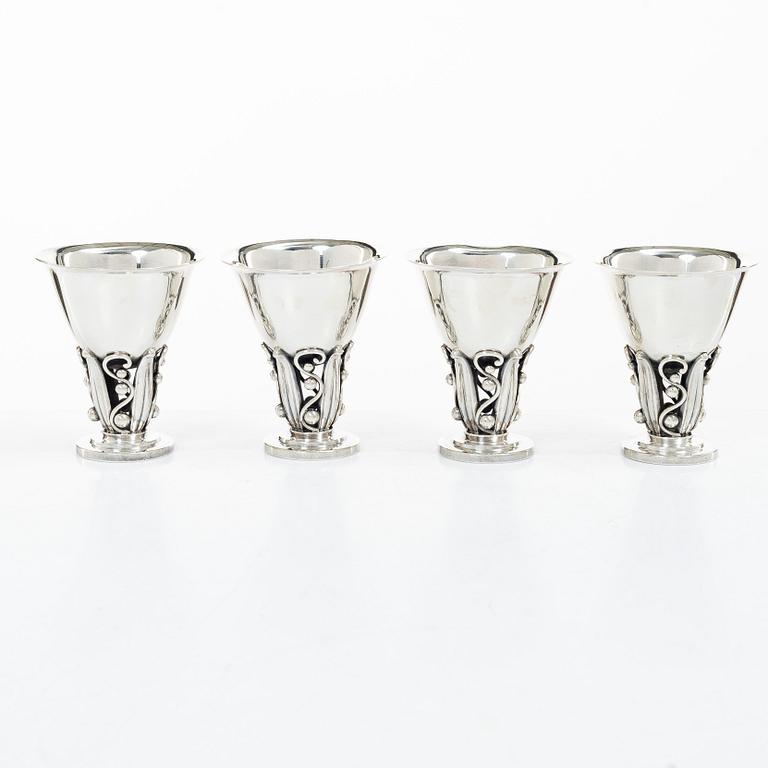 Evald Nielsen, four sterling silver beakers/cups on a foot, Denmark 20th century.
