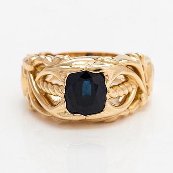 An 18K gold ring with a sapphire.