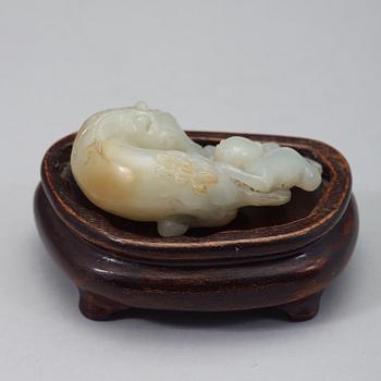 A Chinese nephrite figure of a reclining horse and a monkey, early 20th Century.