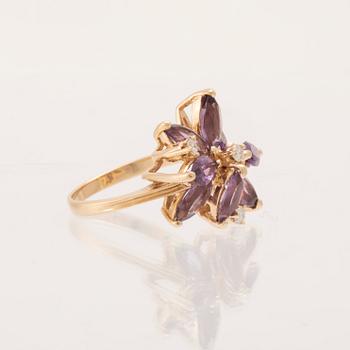 A 14K gold cocktail ring set with round brilliant-cut diamonds and navette-cut amethysts.