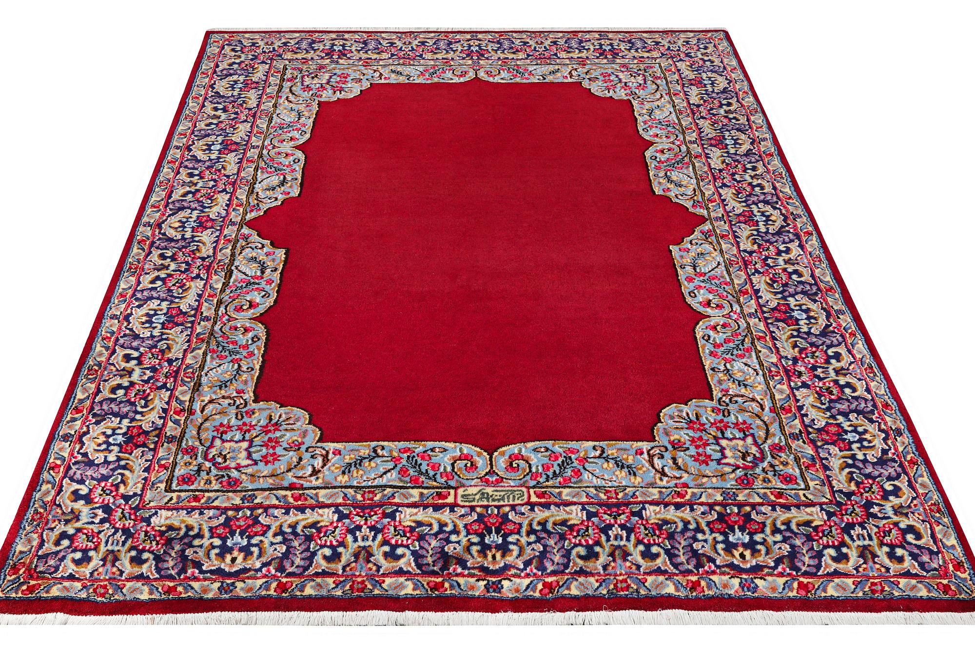 An old Kerman carpet, signed, c. 290 x 208 cm.