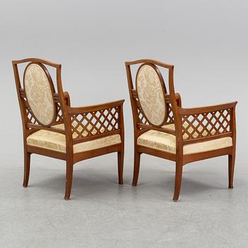 A mahogany sofa, with two armchairs and a round table, early 20th Century.
