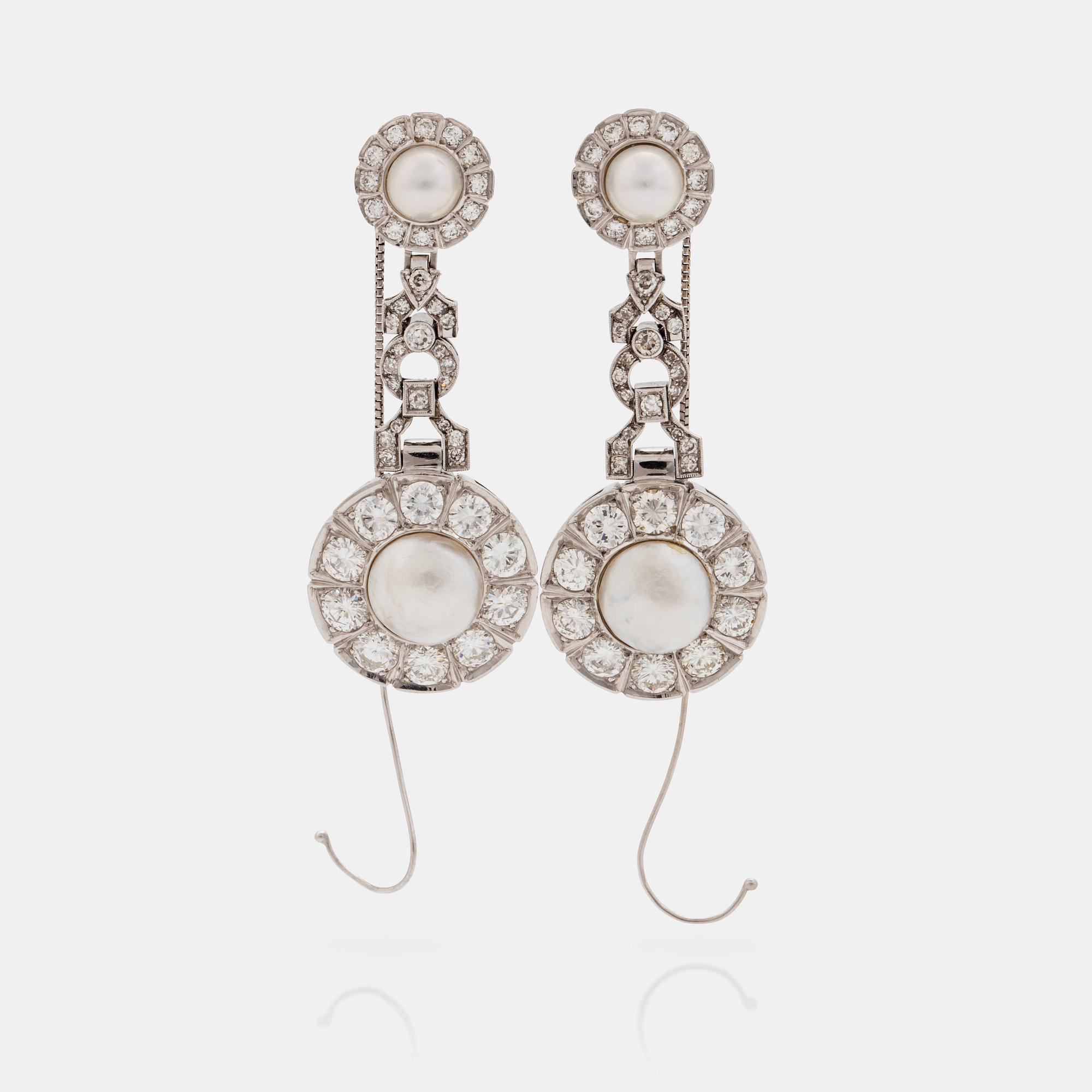 A pair of probably natural saltwater pearl, cultured pearl and brilliant cut diamond earrings.