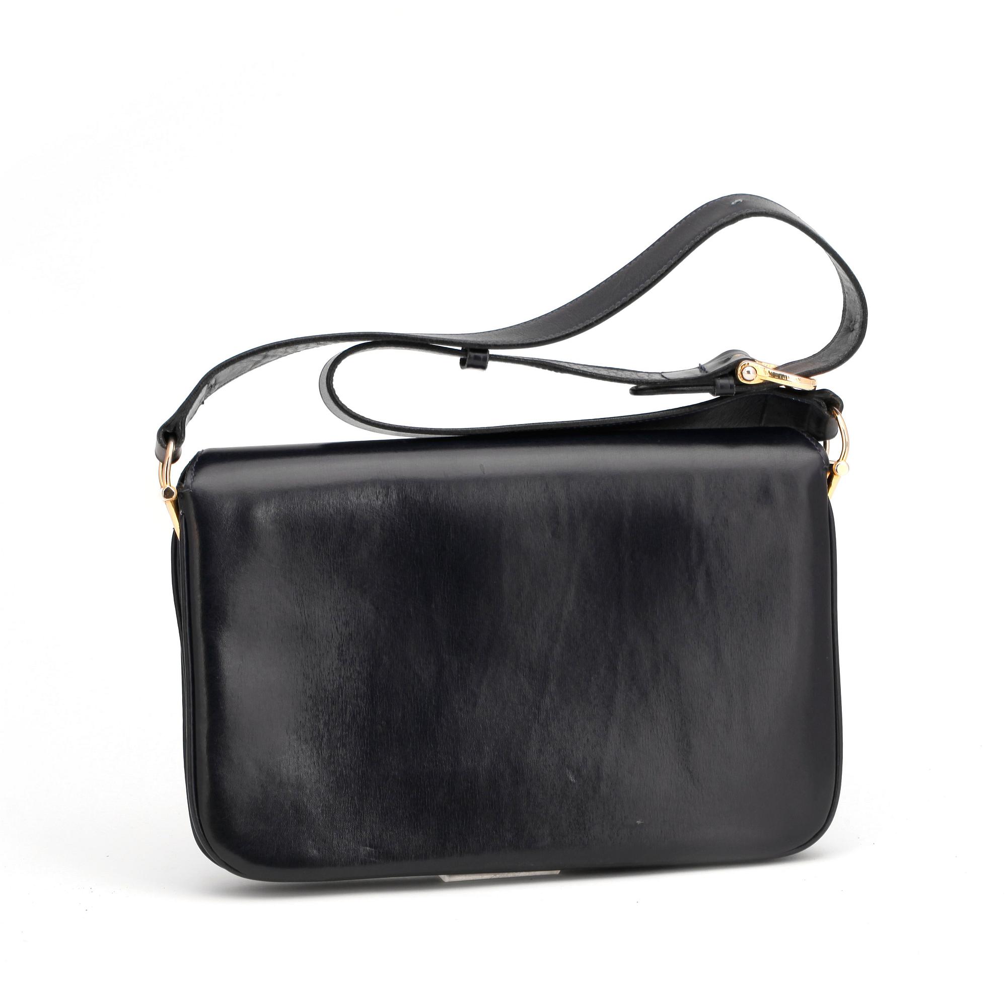 CÉLINE, a dark blue leather shoulder bag.