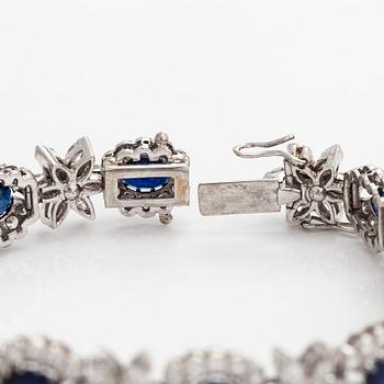 A platinum bracelet, set with oval faceted sapphires and brilliant-, marquise-, and single-cut diamonds.