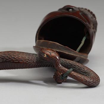 A Japanese bamboo box in the form of a skull with snake, Meiji period (1868-1912).