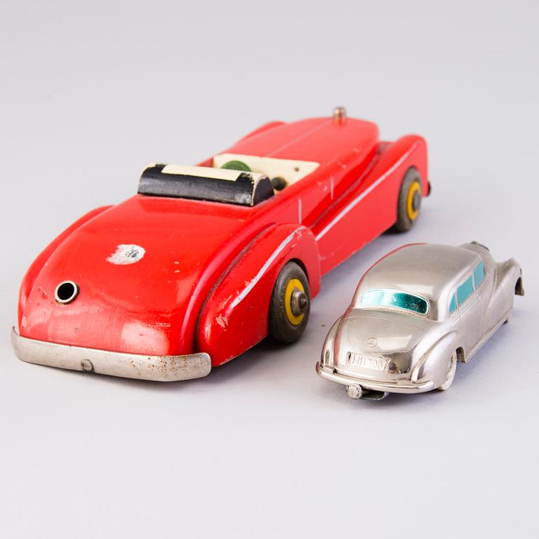 Two mid-20th century toy cars, chromed metal and wood.