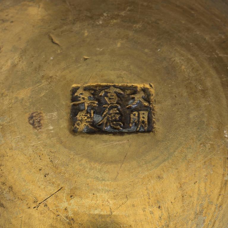 A Chinese brass bowl and Japanese dish, 20th century.