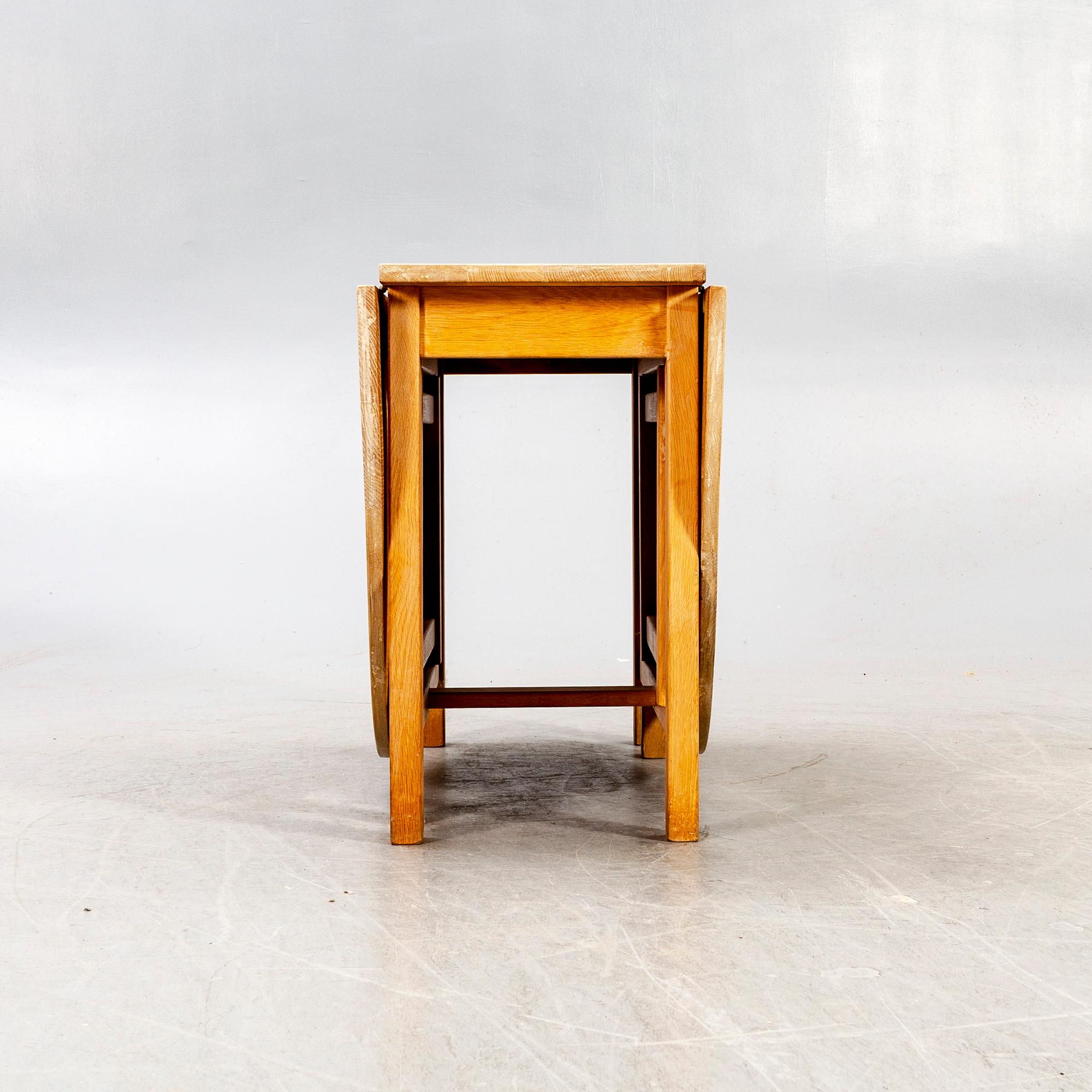 A 20th century oak folding table.