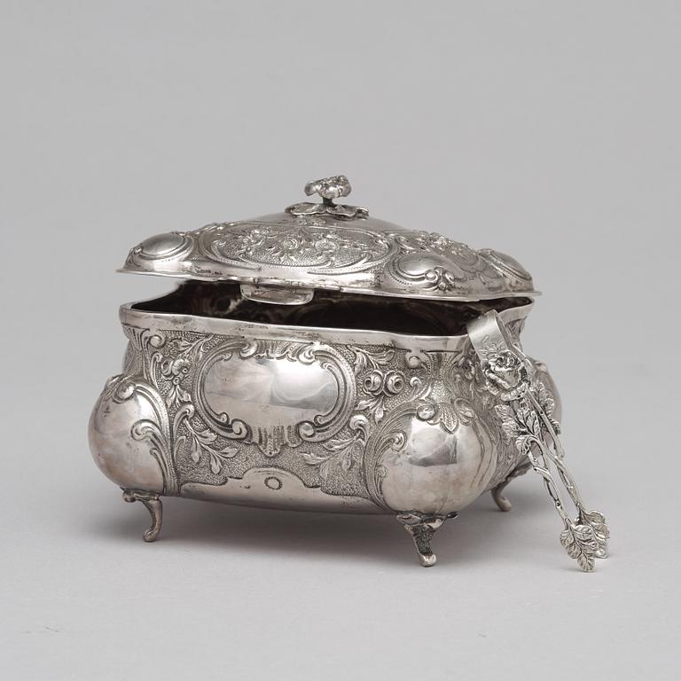 A silver sugar box.