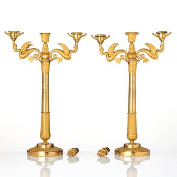 A pair of ormolu three-branch Empire candelabra, early 19th century.