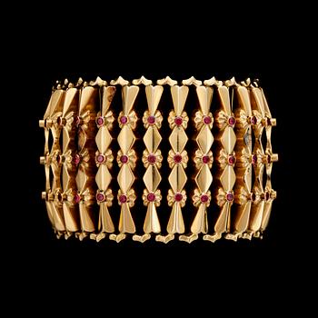 1002. A gold and ruby bracelet, 1950's.