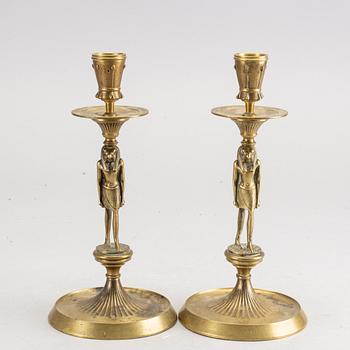 A pair of early 20th century brass candle sticks.