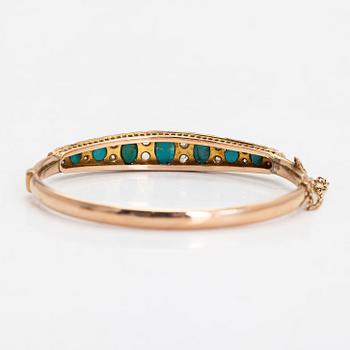 An approximately 9-11K gold bangle, with turquoises and rose-cut diamonds.