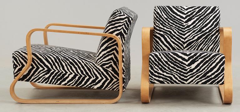 A pair of Alvar Aalto 'Padded Paimio' closed-framed armchairs, by O.y Huonekalu-ja Rakennustyötehdas A.B for Artek.