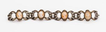 A silver and sea shell cameo bracelet.