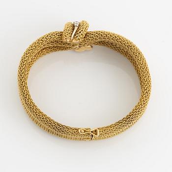 An 18K gold Bucherer bracelet set with round brilliant-cut diamonds.