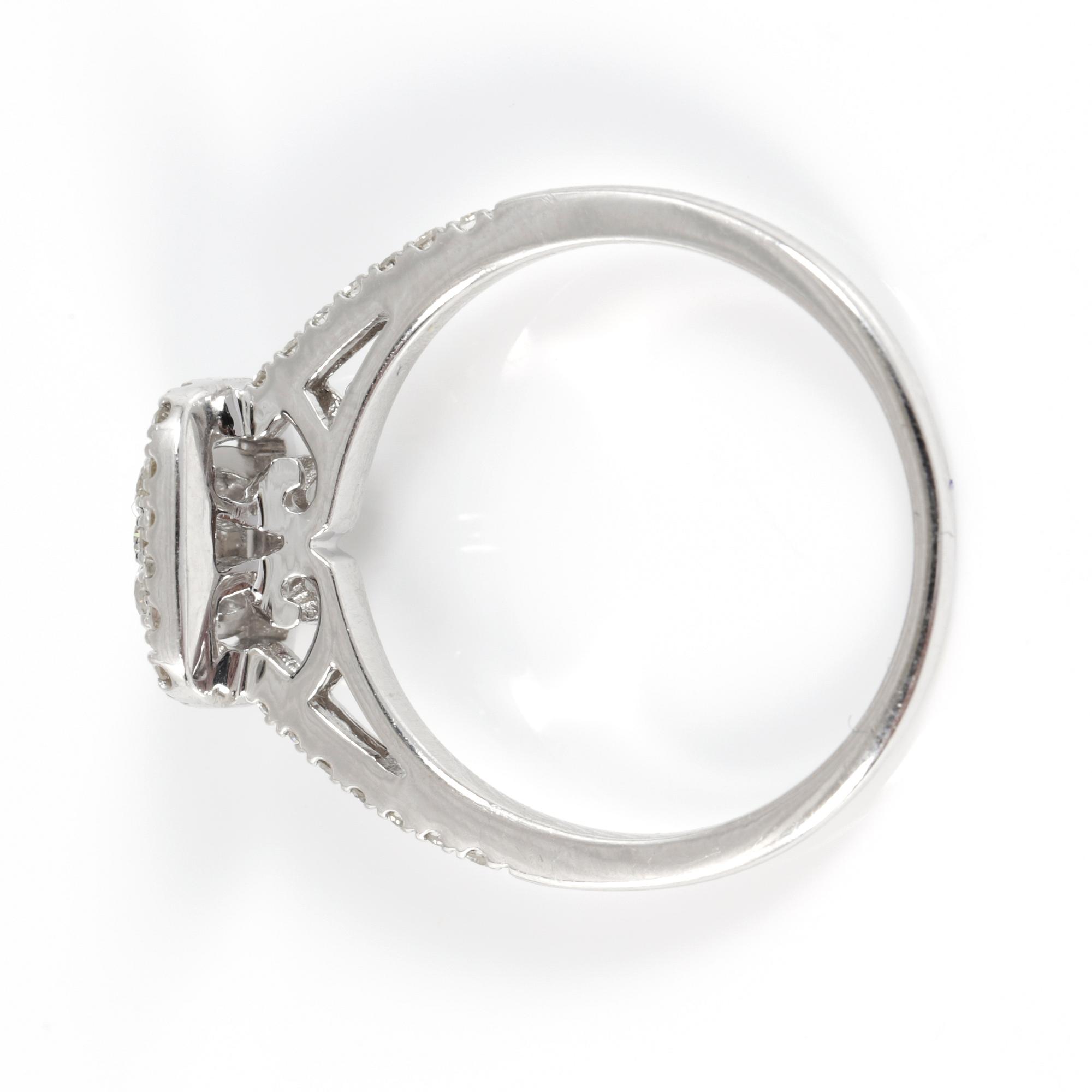 RING, 14K vitguld med central prinsesslipad diamant omgiven av briljantslipade diamanter tot ca 0,71 ct. Vikt 3,22 g.