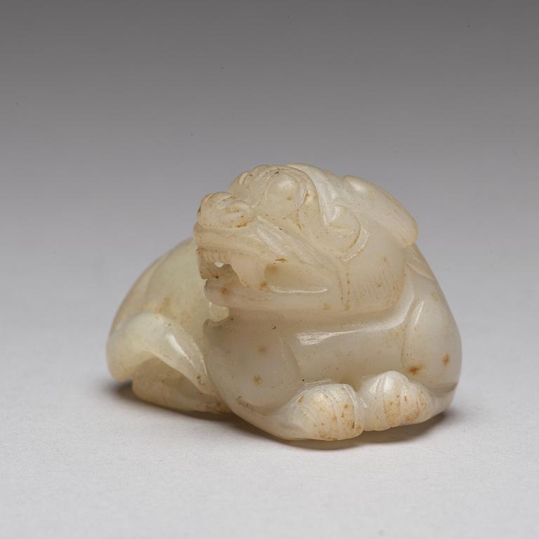 A Chinese nephrite snuff bottle, pendant and figurine.